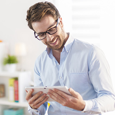 Young Man smiling at tablet