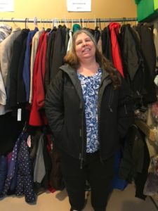 A local woman receives a coat at the Store house